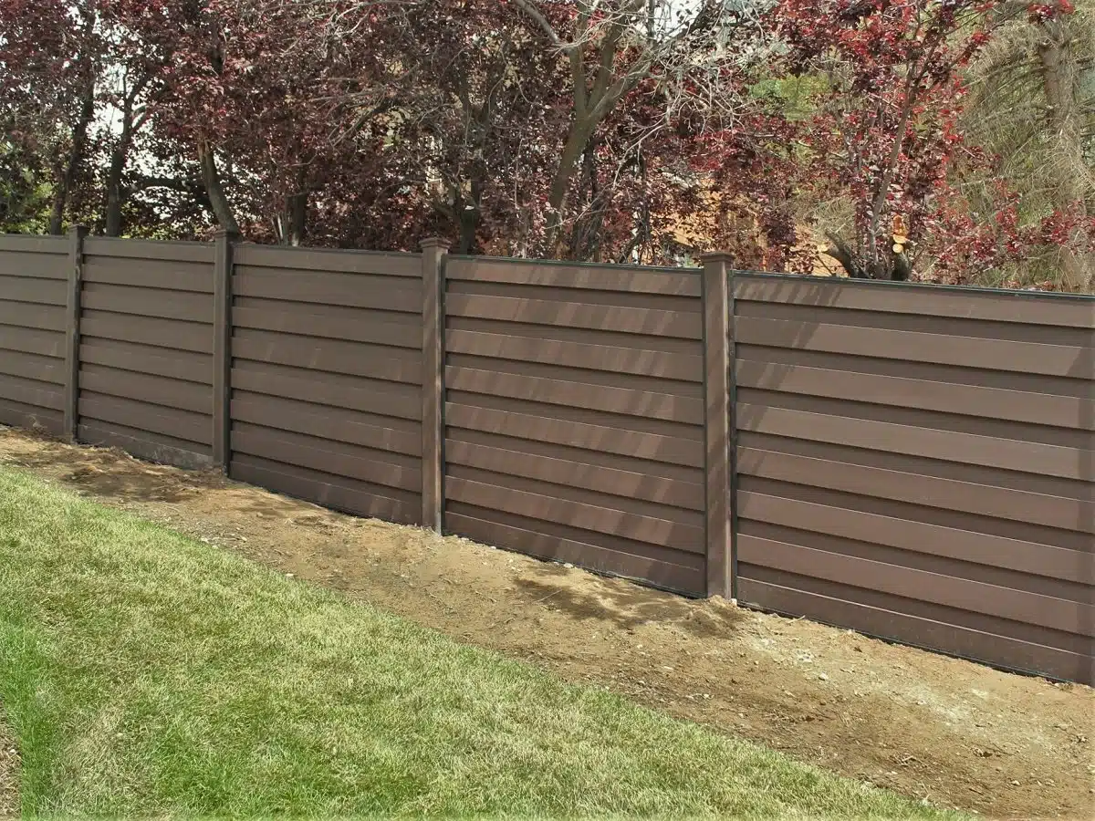 trex-fencing-sloping-with-ground A sloped Trex horizontal fence on a hill