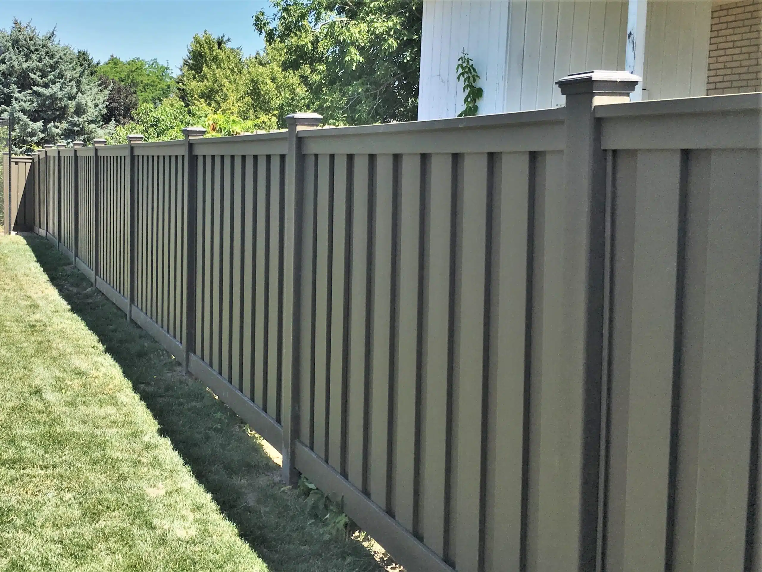 6 ft Tall Trex Fence Panels Fence panels made of Trex Seclusions privacy fencing installed along the property line of a backyard.